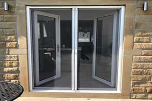 Image of a door fly screen, featuring a magnetic closure that allows for easy entry and exit while keeping insects out. The screen is designed to fit securely over a door frame, with fine mesh material ensuring good visibility and airflow, making it an effective and convenient solution to keep flies out