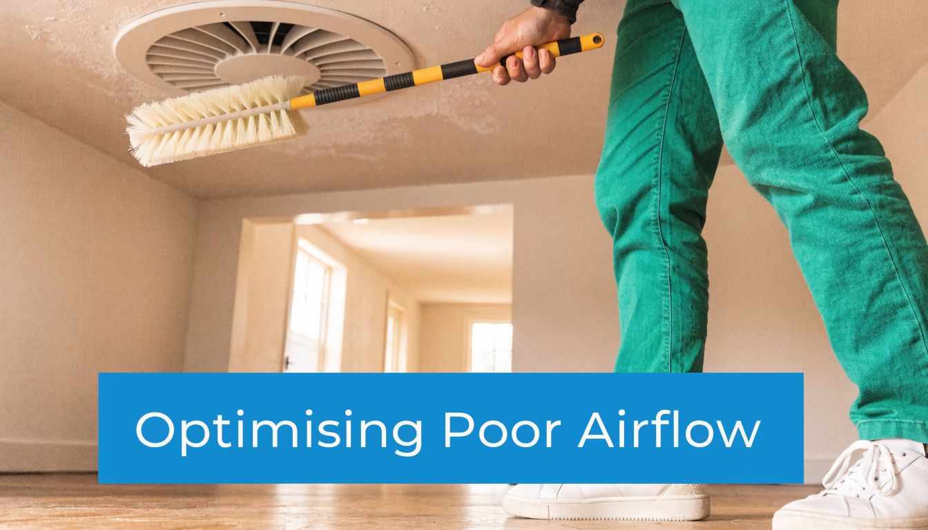 Fly Screens A person cleaning a circular ceiling air vent with a long handled brush to improve home ventilation.
