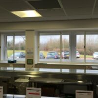 Sliding fly screens in a commercial kitchen Sliding fly screens for commercial kitchens