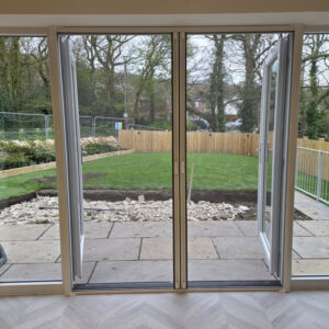 Roller fly screen door with the mesh in the closed postion